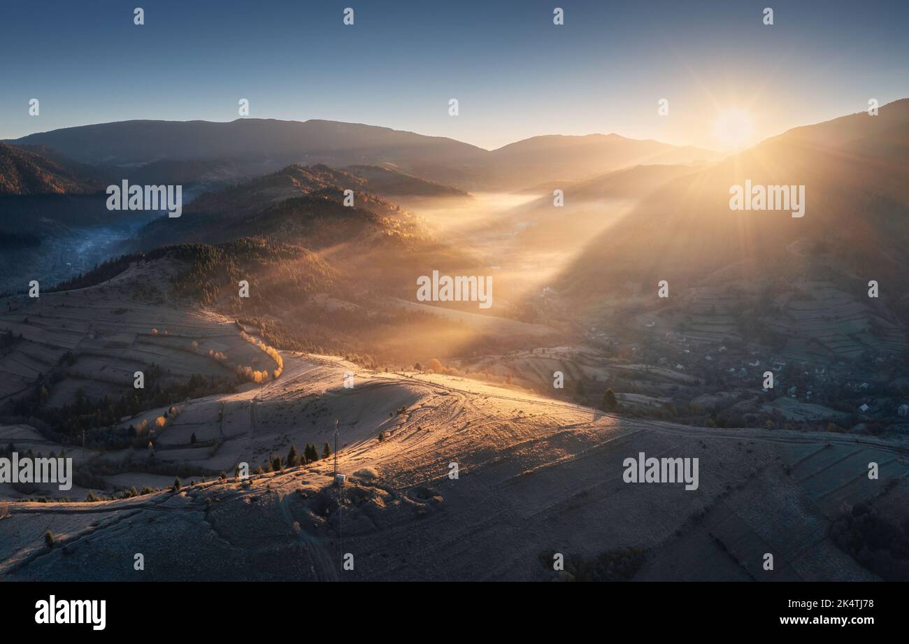 Aerial view of mountains and hills in low clouds at sunrise Stock Photo