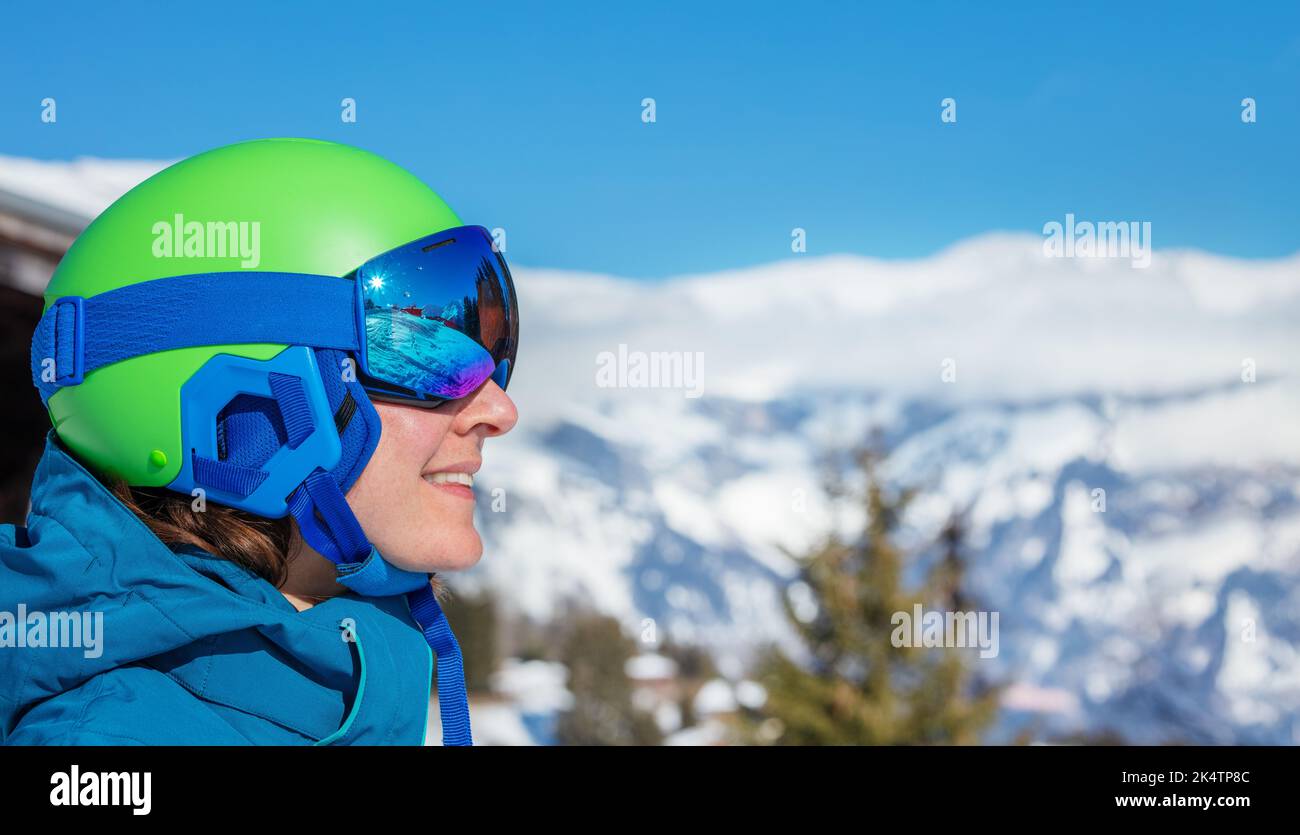 Portrait of a happy smiling woman in ski helmet and mask Stock Photo
