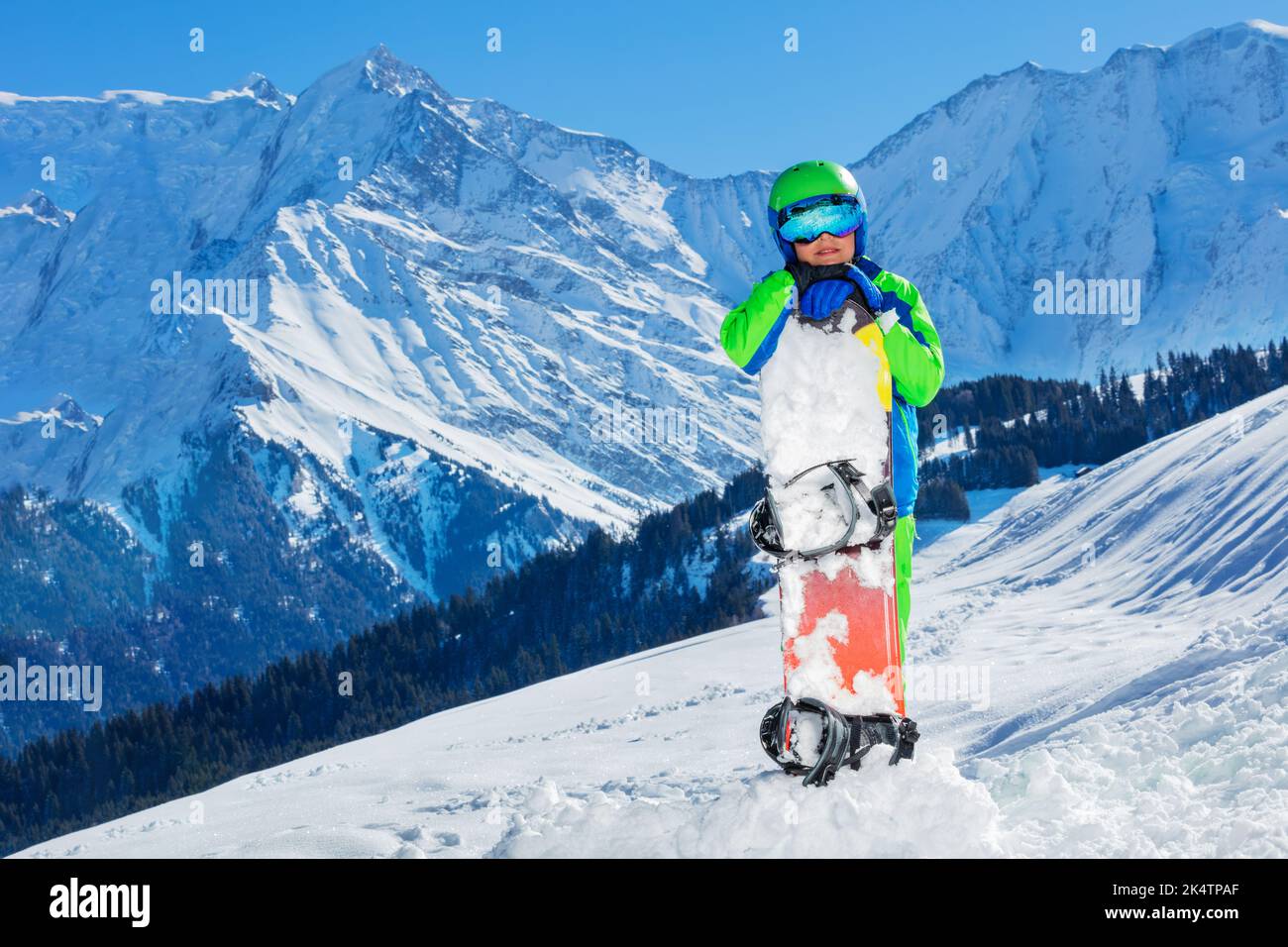Portrait of a 11 years old happy boy in helmet and ski mask Stock Photo