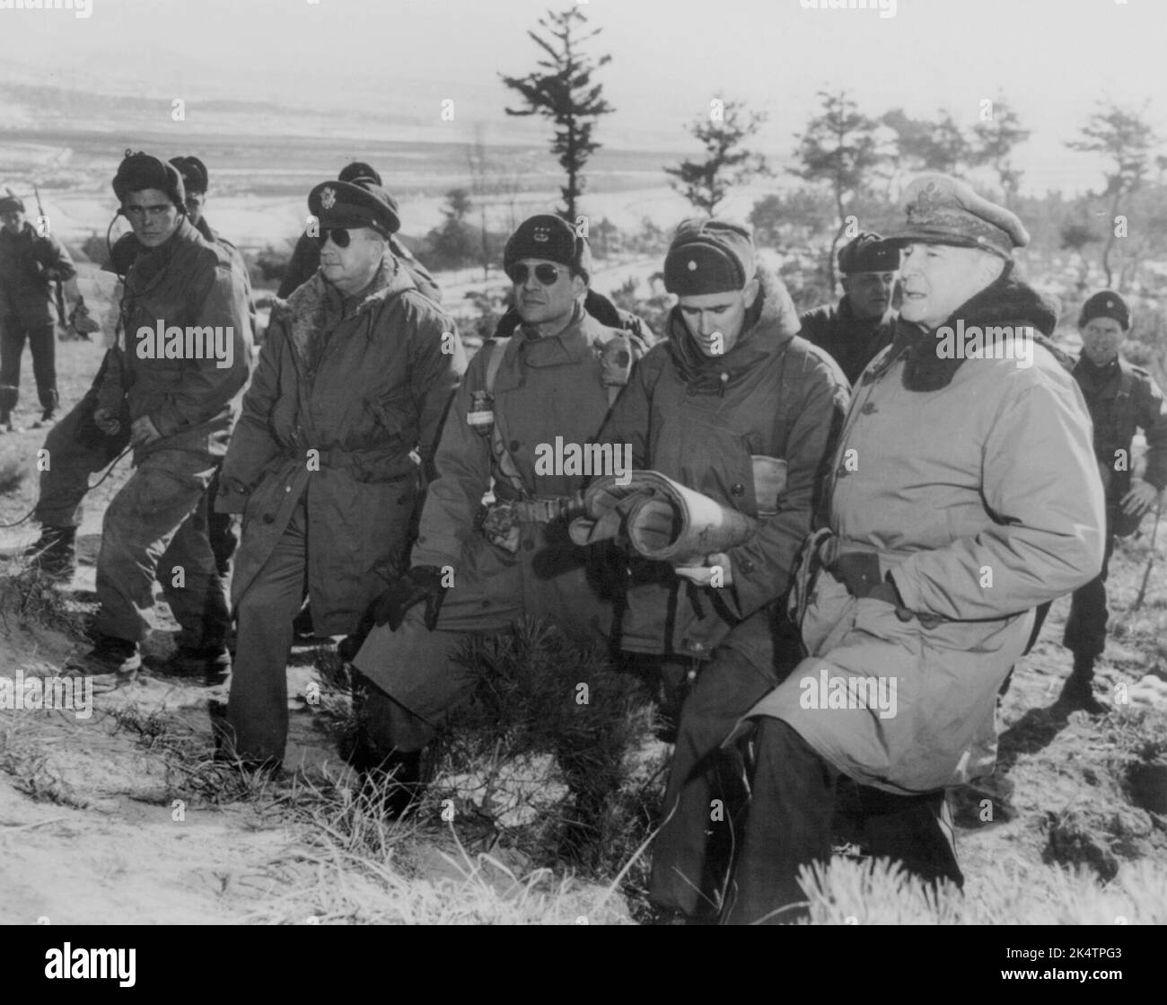 SUWAN, KOREA - 28 January 1951 - US Army General Douglas MacArthur, Major-General Courtney Whitney, Lt General Matthew B Ridgway, and Major General Wi Stock Photo