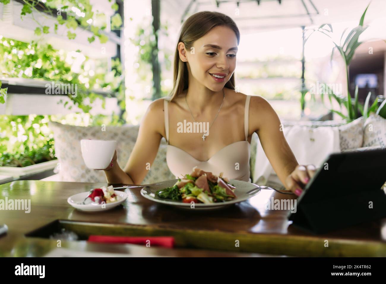 Beautiful cute asian young businesswoman in the cafe, using digital tablet Stock Photo