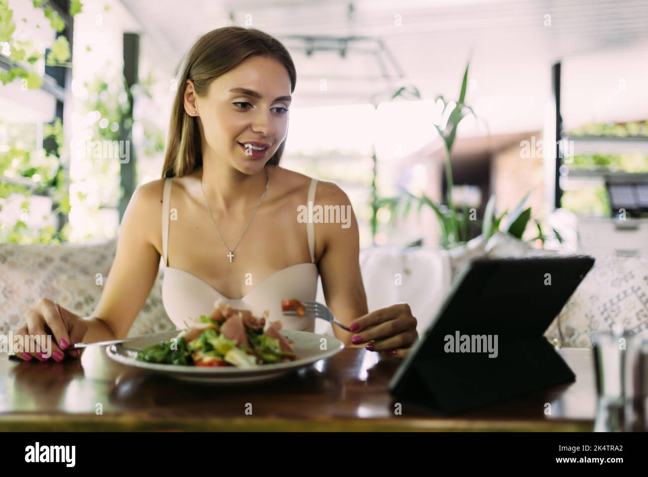 Beautiful woman using digital tablet at cafe Stock Photo