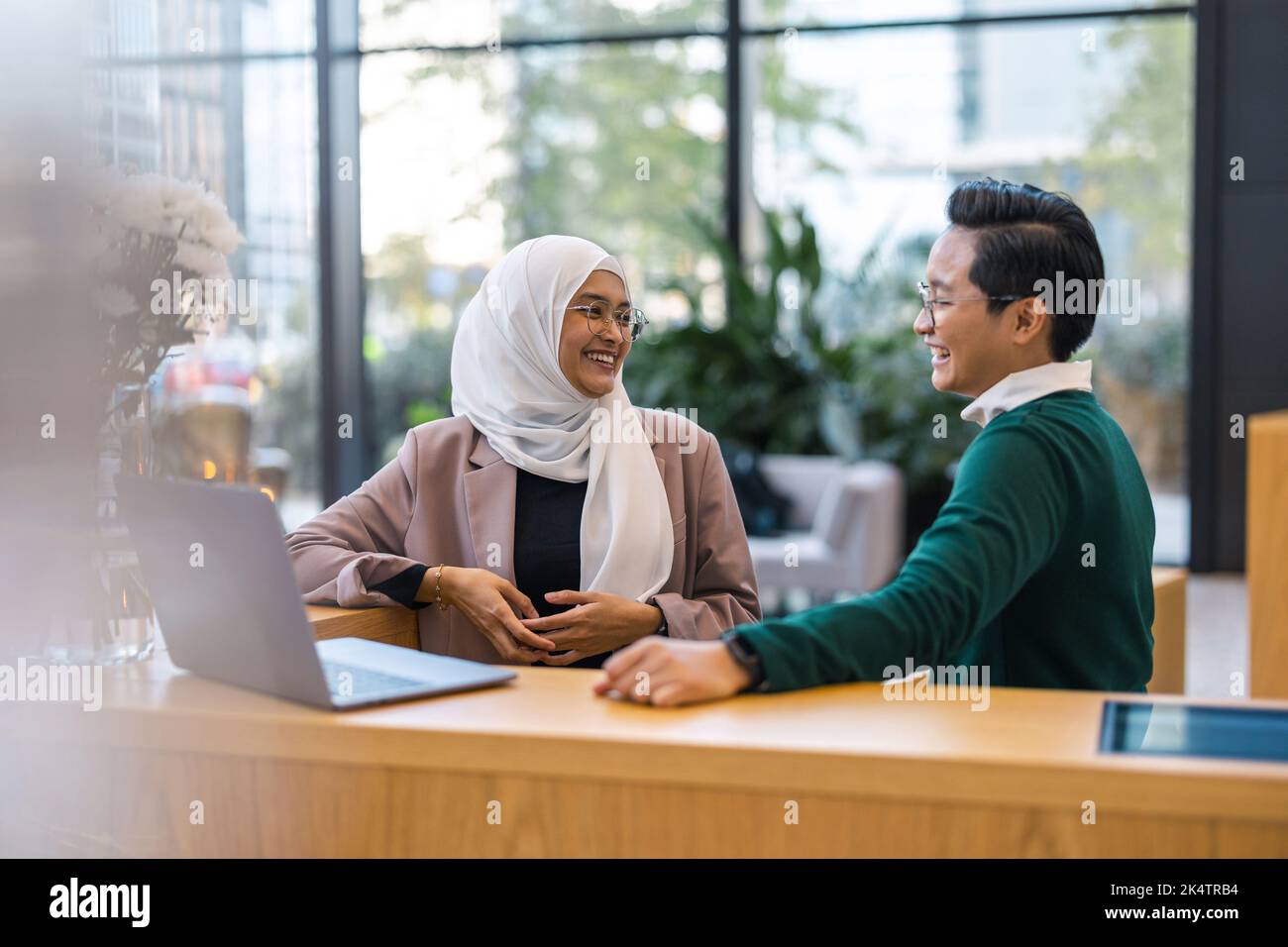 Young business couple using laptop in the office Stock Photo