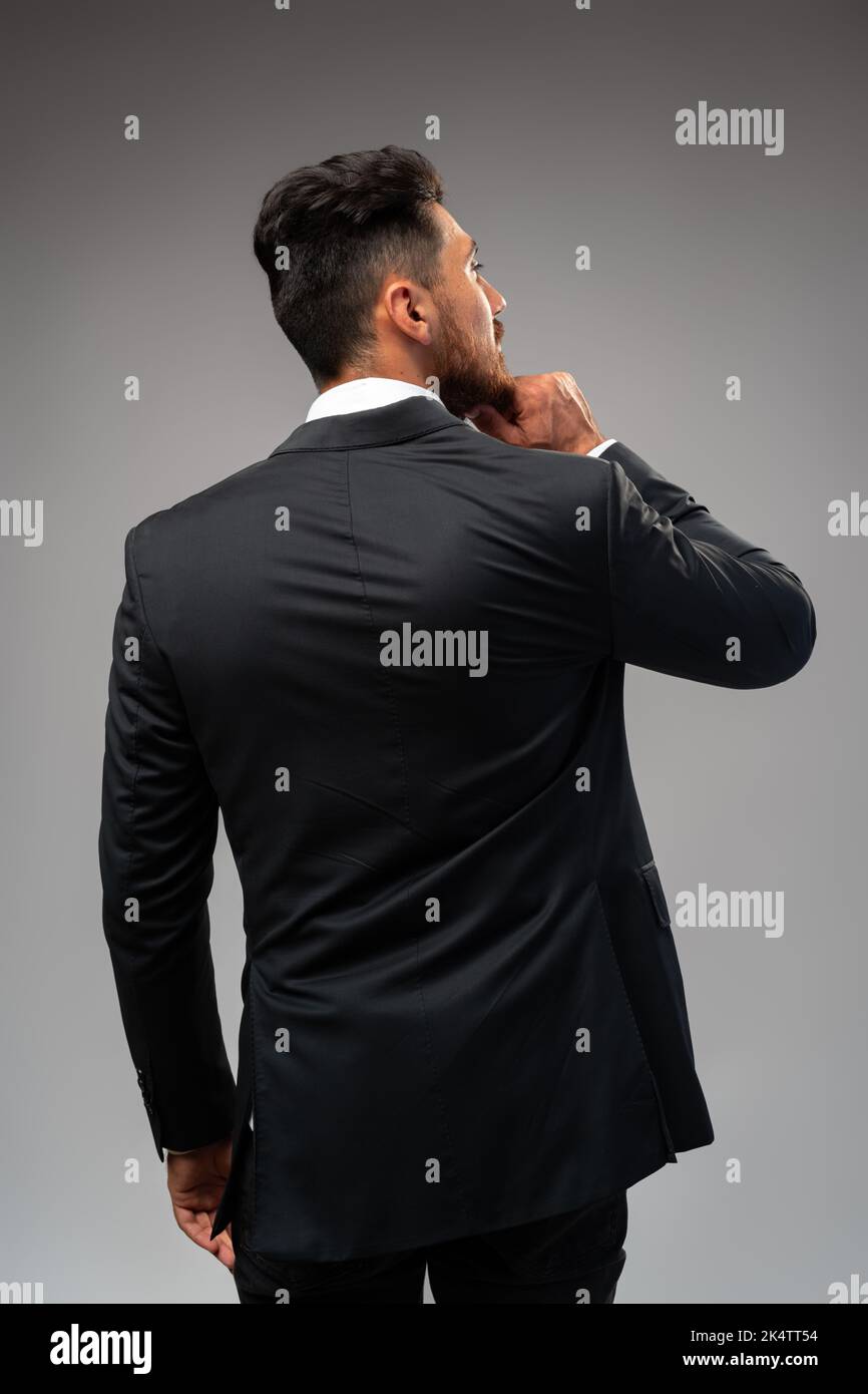 Studuo shot of thinking businessman standing over gray background Stock Photo