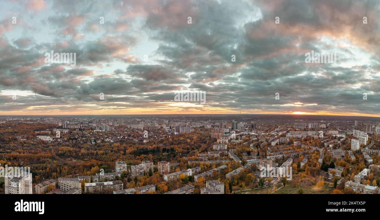 Aerial evening epic panorama view on Kharkiv city district. Multistory residential buildings, streets, park in autumn sunset light Stock Photo