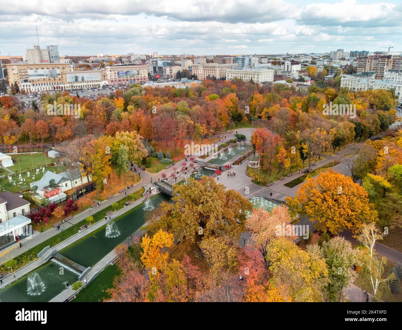 Aerial view on vibrant autumn Shevchenko City Garden with fountains. Tourist attraction in colorful park in Kharkiv, Ukraine Stock Photo