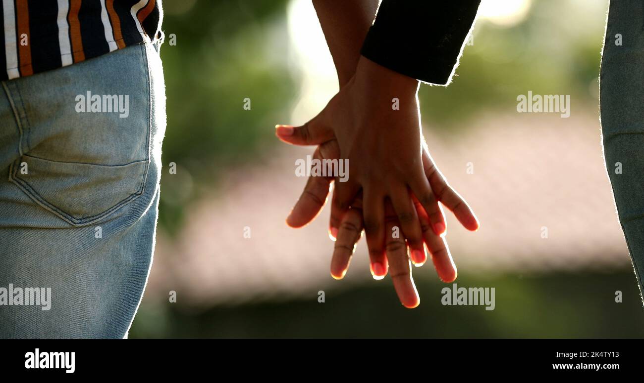 Two people joining hands, African union and support Stock Photo - Alamy