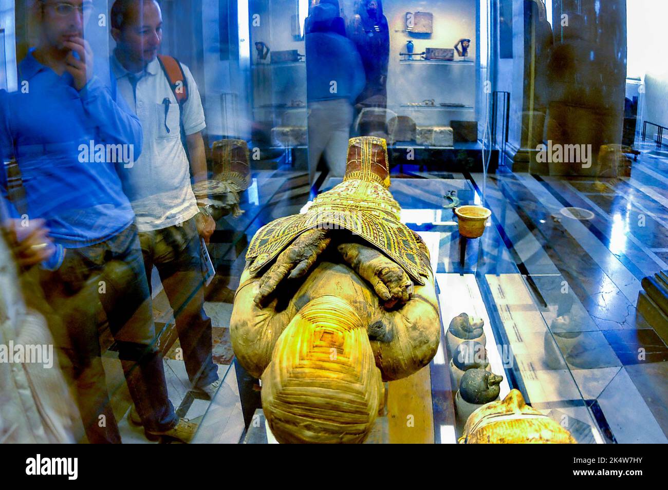 PARIS, France  - Tourists in Louvre Museum, Egyptian Dept. Collection, Looking at an Ancient Mummy. on display in Case Stock Photo