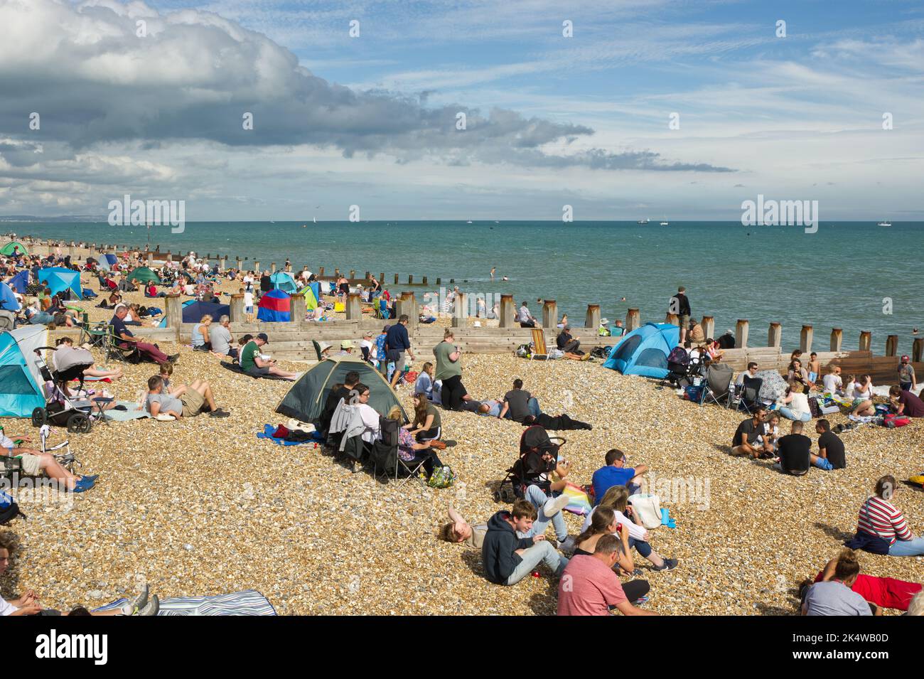 Lots of people crowding on the beach at Eastbourne, East Sussex, England. Waiting for the airshow to start. Stock Photo