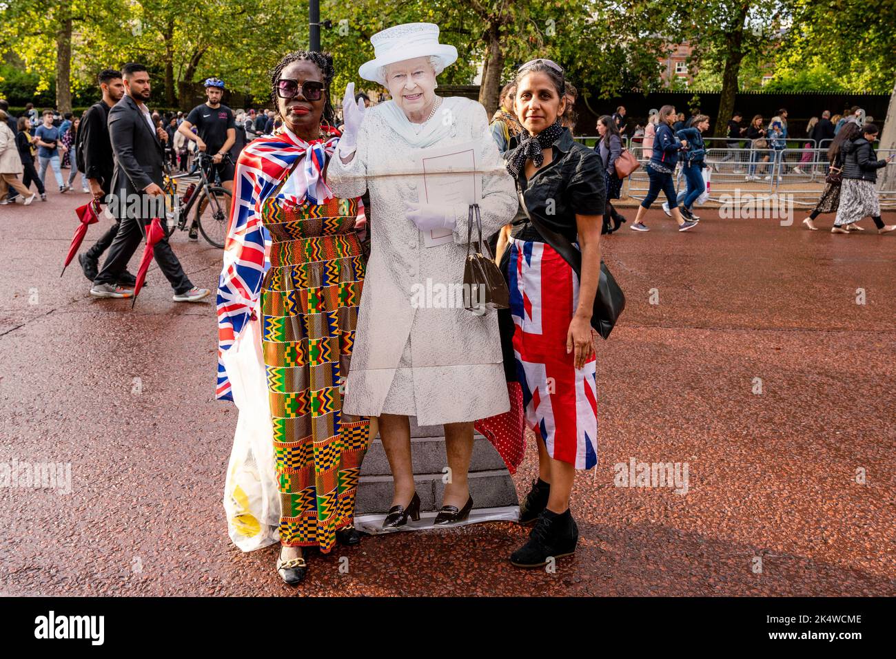 The Day After Queen Elizabeth II Passes Away Two Women Carry A Life Size Cardboard Cut-Out Of The Queen In Tribute, The Mall, London, UK. Stock Photo