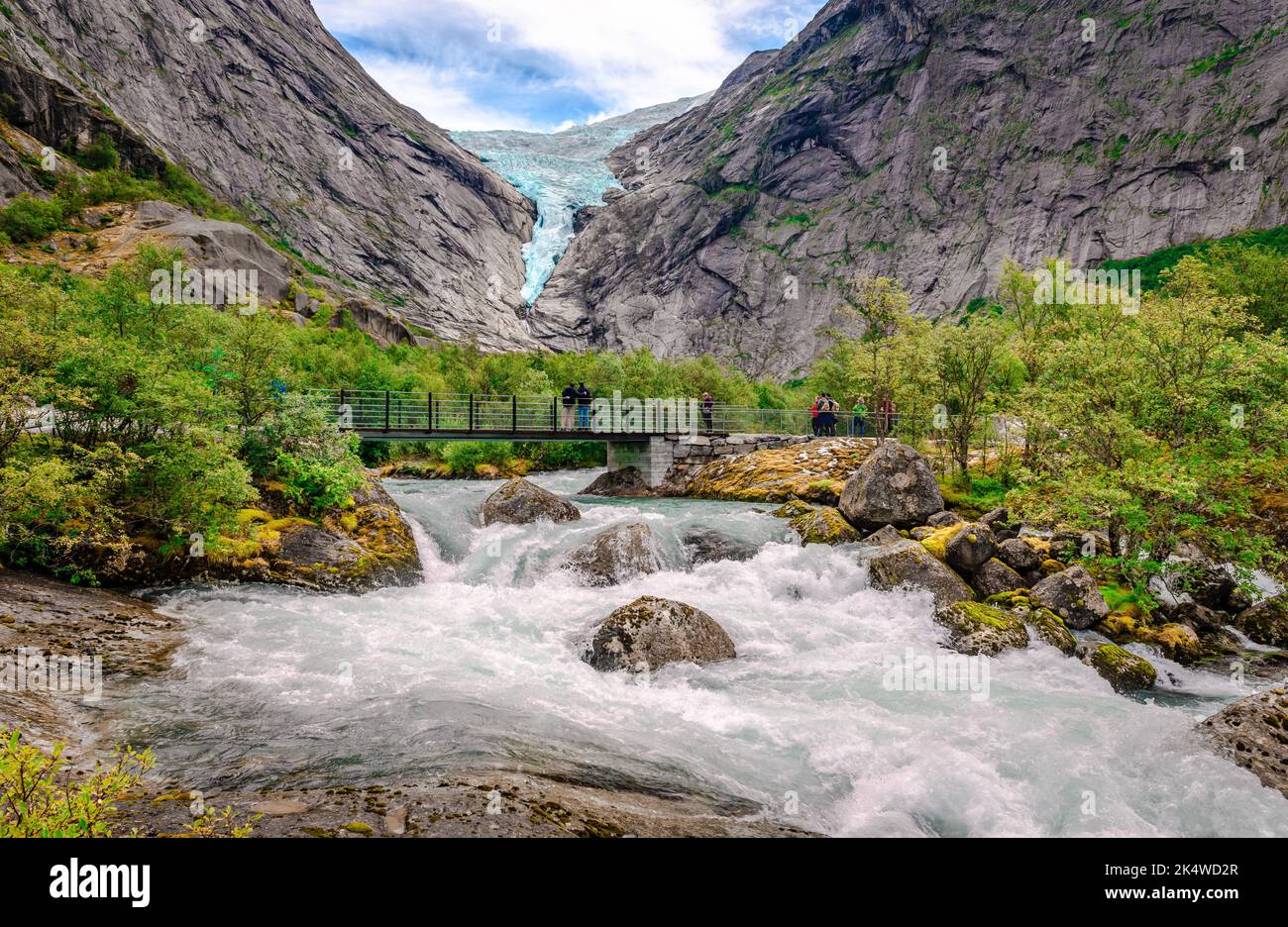 Briksdalen, Norway - August 22 2022: View of Briksdal valley with Briksdalselva (the river) and the Briksdalsbreen (the Glacier) in the background. Pa Stock Photo