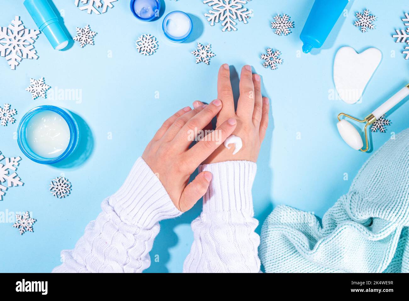 Woman using winter cream for hands. Girl hands with cream flat lay on