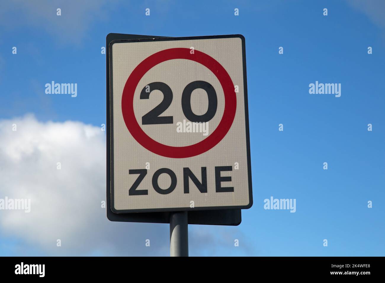 20 Miles per hour speed limit sign against a blue sky Stock Photo
