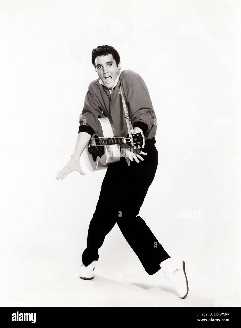 Elvis Presley posing with his Gibson guitar. Jailhouse Rock (MGM, 1957). Publicity Still. Stock Photo