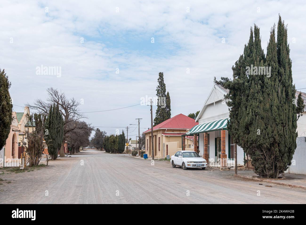 HANOVER, SOUTH AFRICA SEP 2, 2022 A gravel street scene, with buildings, a vehicle and trees