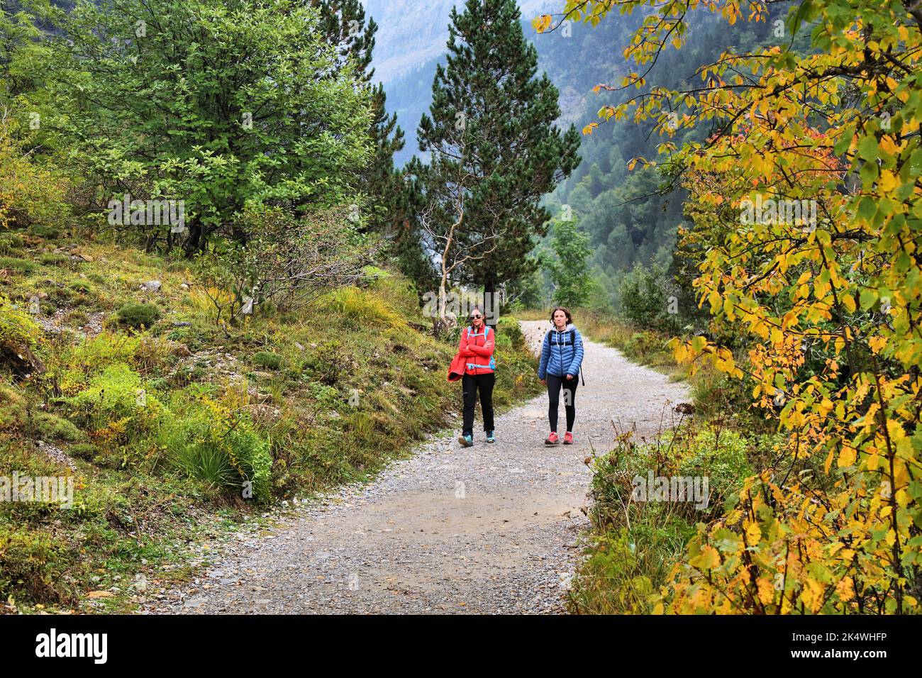 PYRENEES, SPAIN - SEPTEMBER 25, 2021: Hikers enjoy a hiking trail in Ordesa y Monte Perdido National Park in Pyrenees. Stock Photo