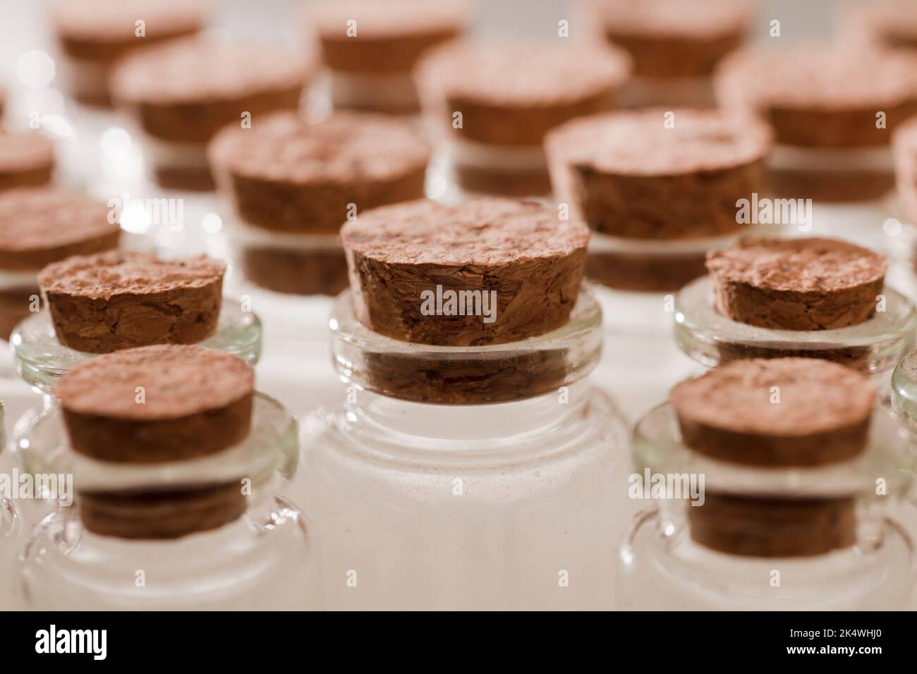 glass jars with corks, soft green background Stock Photo