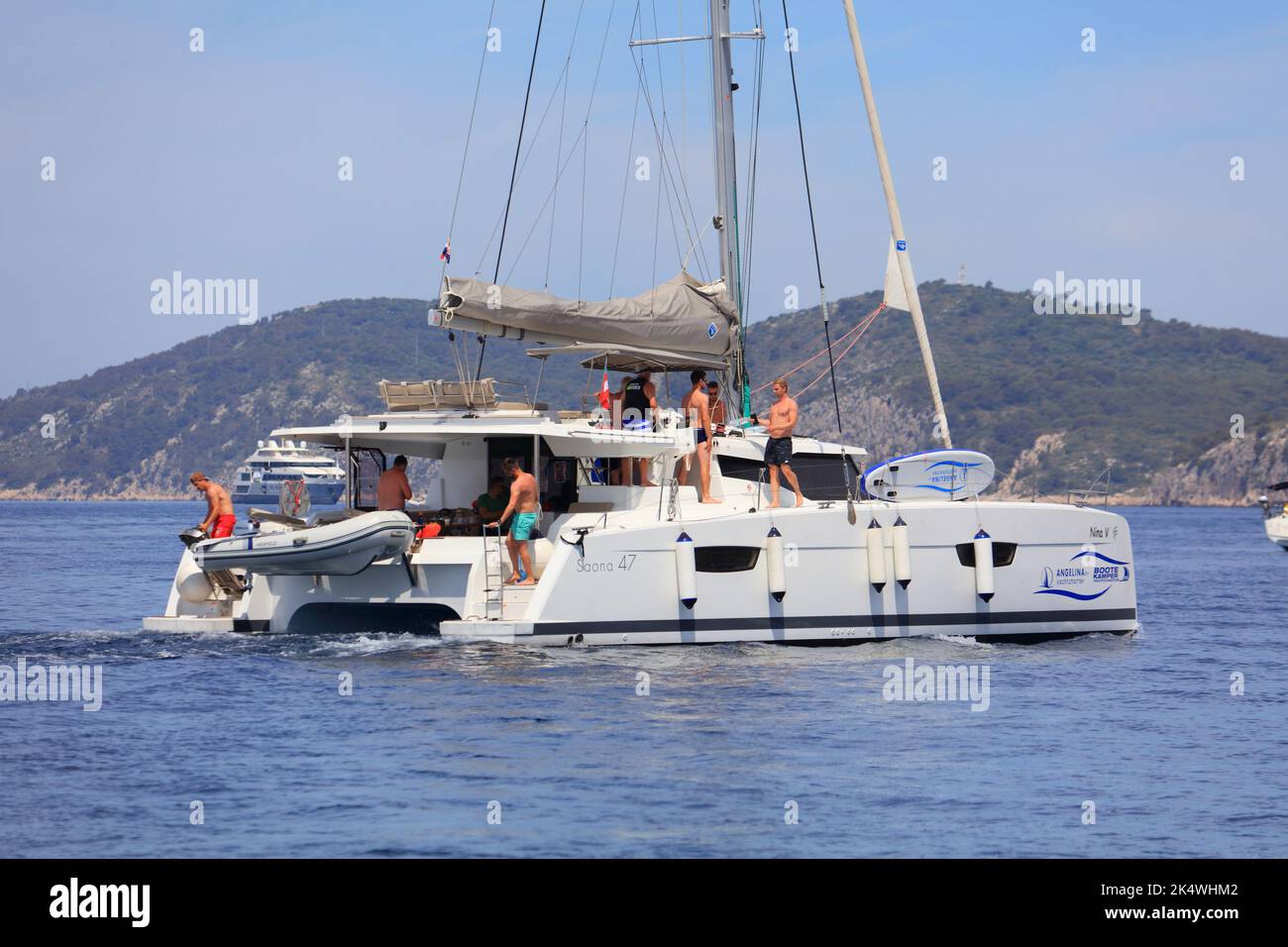 HVAR, CROATIA - JUNE 16, 2021: People sail on Fountaine Pajot Saona 47 yacht in Adriatic Sea. Fountaine-Pajot is a French pleasure boat manufacturing Stock Photo