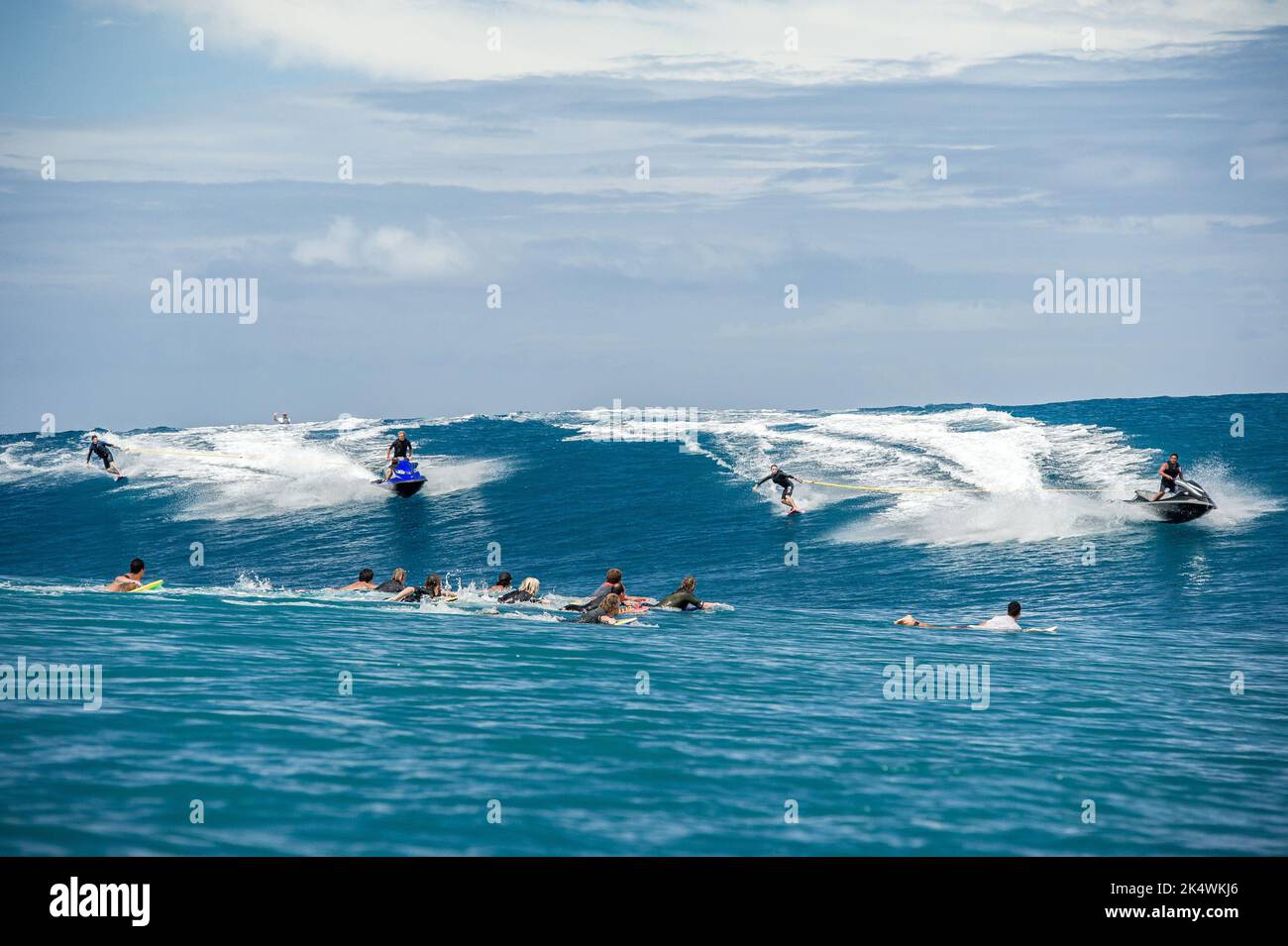 SURFING Hawaian surfers Bruce Iron towed in by Laird Hamilton and Billy Kemper towed in by Tahitian surfer Raimana Van Bastolaer at Teahupoo, during a big swell on September 11, 2014 at Teahupoo in Tahiti, French Polynesia - Photo: Julien Girardot/DPPI/LiveMedia Stock Photo