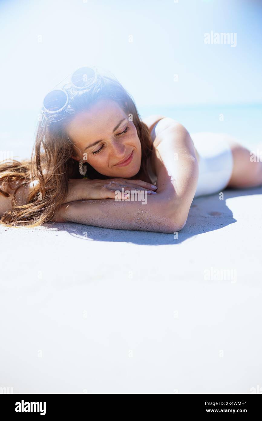 relaxed stylish woman laying at the beach Stock Photo - Alamy