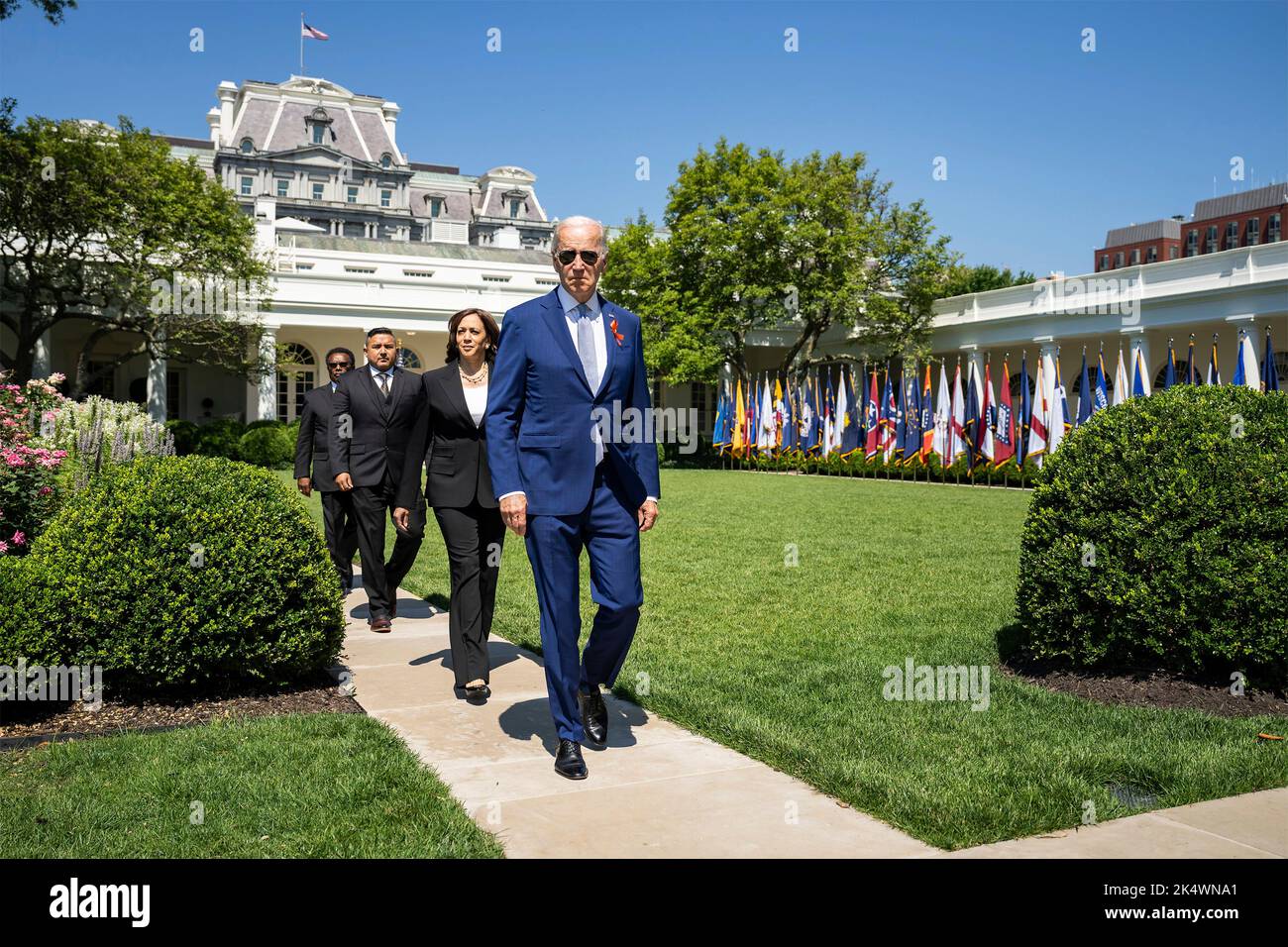 Washington, United States. 11 July, 2022. U.S. President Joe Biden, Vice President Kamala Harris joined by guests Garnell Whitfield Jr, and Dr. Roy Guerrero, walk through the Rose Garden to attend an event celebrating the passage of the Bipartisan Safer Communities Act at the White House, July 11, 2022, in Washington, D.C. Washington, United States. 11 July, 2022. Stock Photo