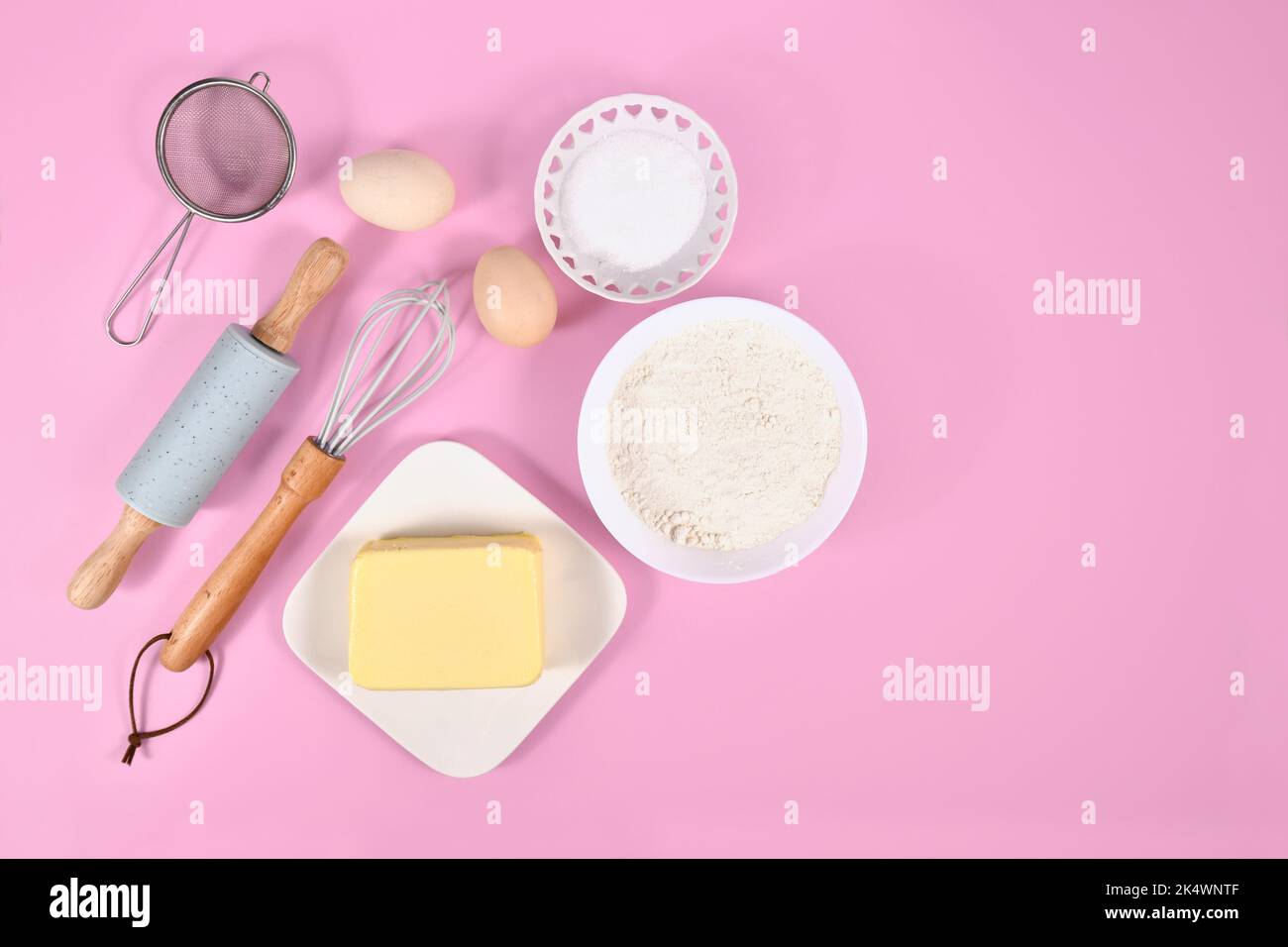 Cake dough ingredients and baking tools on pink background with copy ...