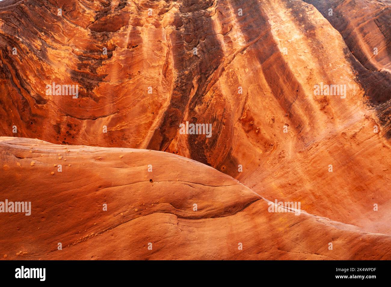 Desert varnish on the wall of Holeman Slot canyon carved by rushing water over thousands of years in Canyonlands National Park, Utah. Stock Photo