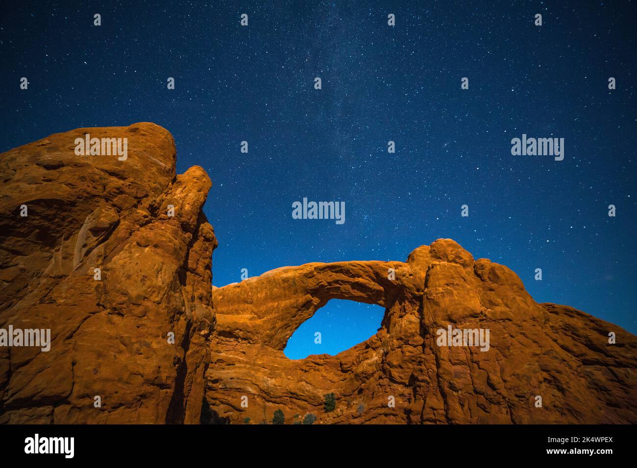 Stars over the South Window lit by light painting.  WIndows Section, Arches National Park, Moab, Utah. Stock Photo