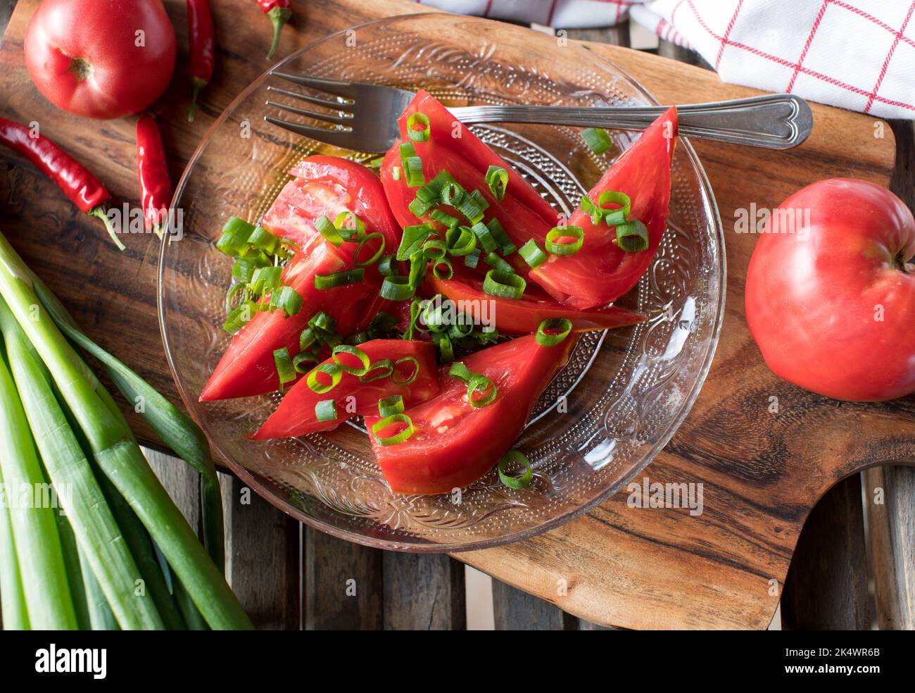 Tomato salad with beefsteak tomatoes, chives and olive oil Stock Photo