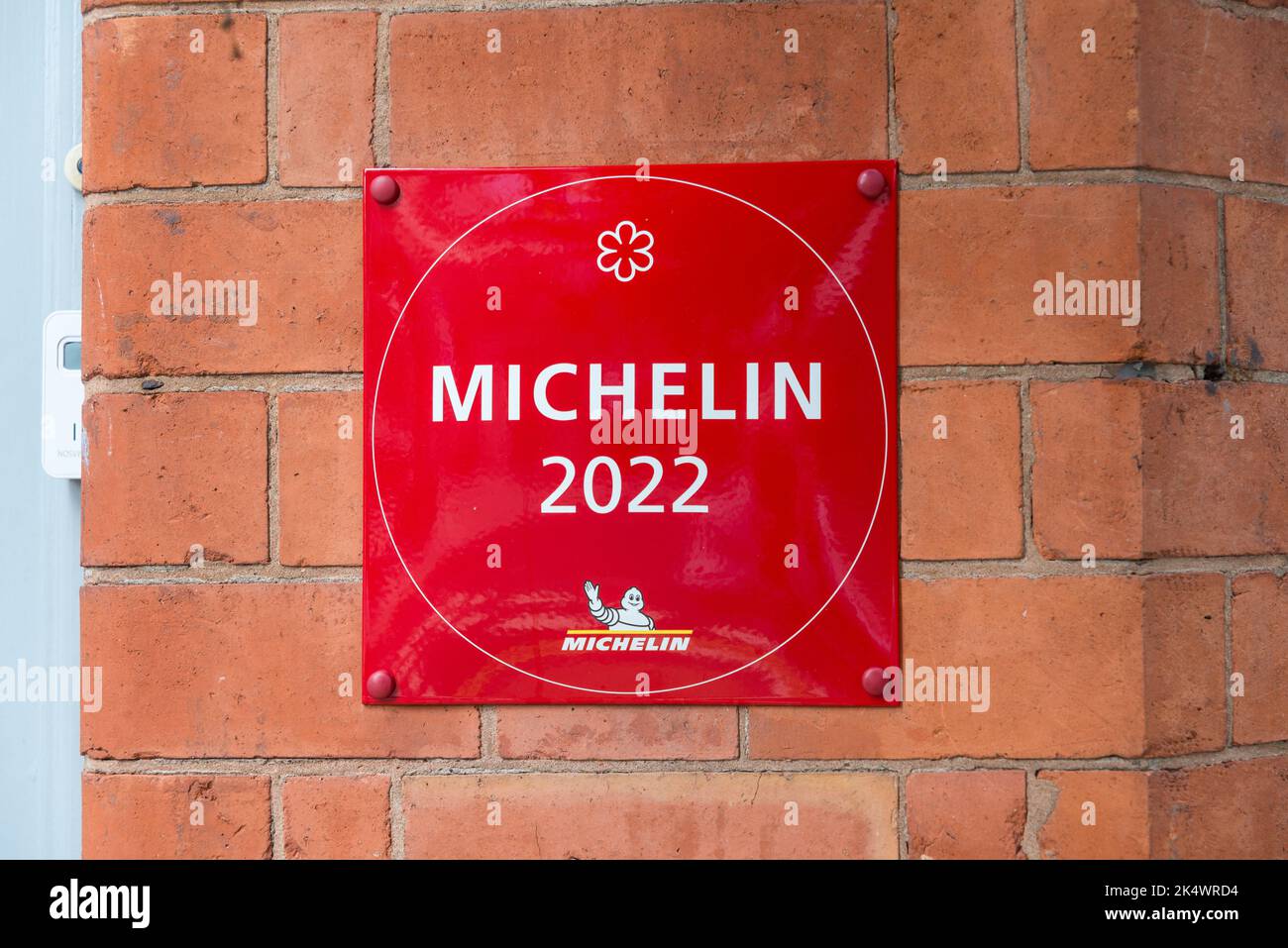 Red wall mounted Michelin 2022 plaque showing Purnells restaurant has one star Stock Photo