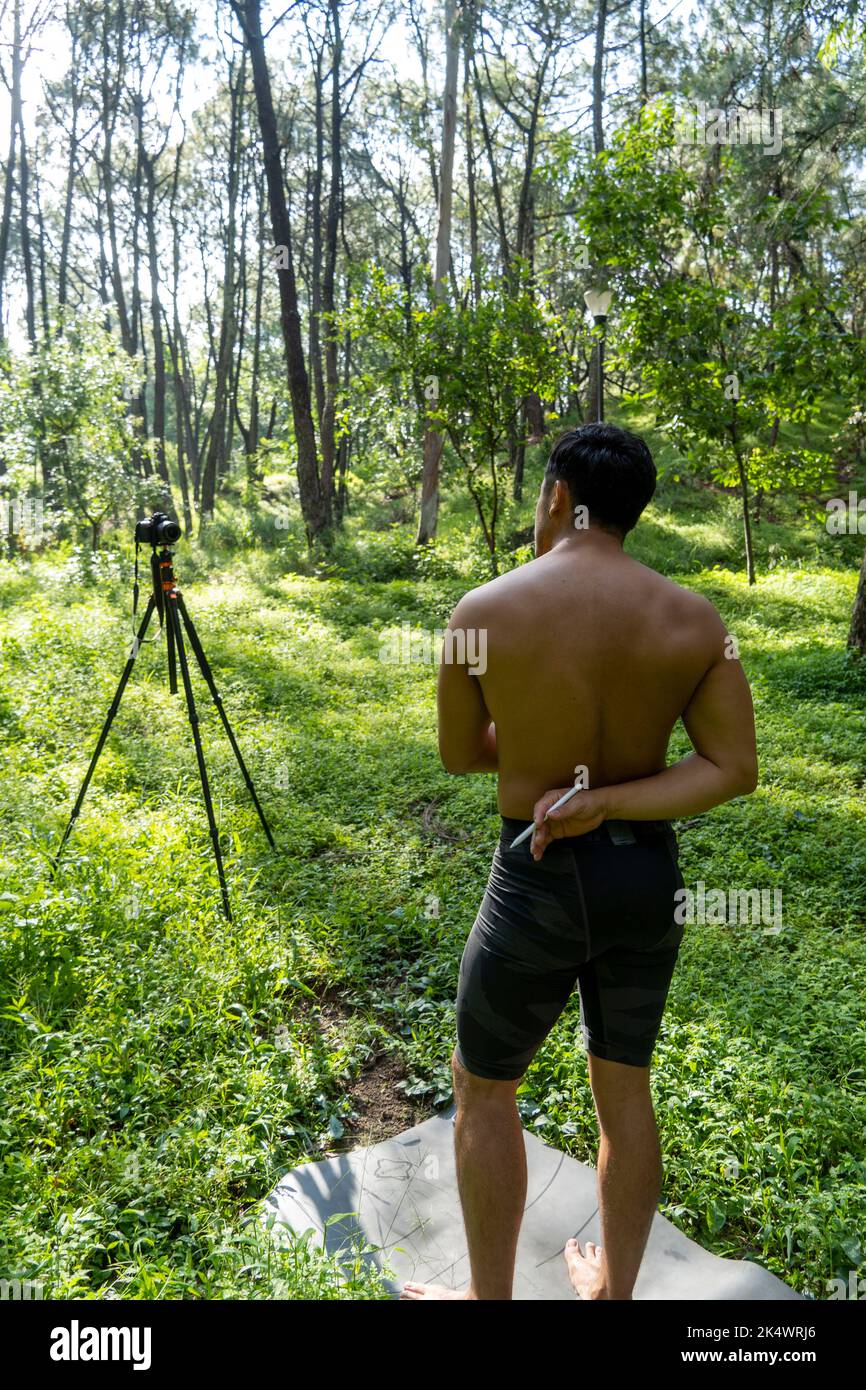 Guy with tablet making video blog on phone. Isolated person giving online classes. Man giving online classes with phone. Stock Photo