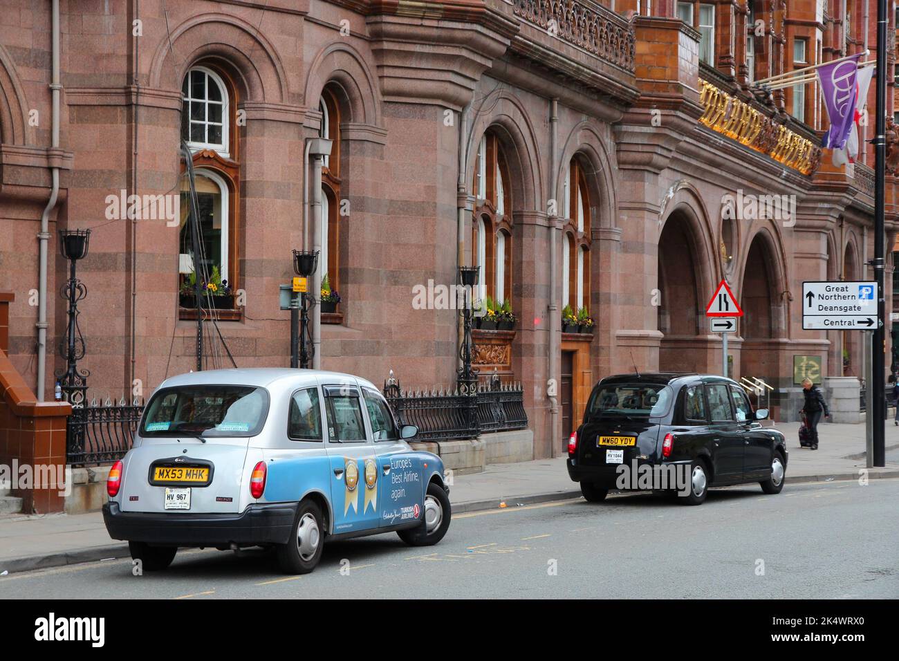 MANCHESTER, UK - APRIL 22, 2013: Taxi cabs wait in Manchester, UK. There are 242,200 taxi and private hire licences in England (as of March 2015). Stock Photo