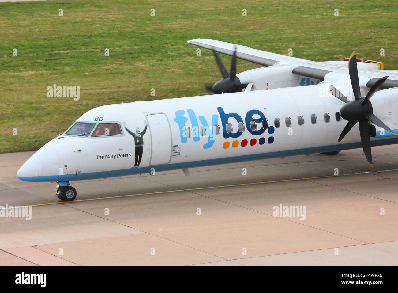 BIRMINGHAM, UK - APRIL 24, 2013: Pilots taxi Flybe Bombardier Dash 8 Q-400 at Birmingham Airport, UK. Flybe carried 7.6 million passengers in 2013. Stock Photo