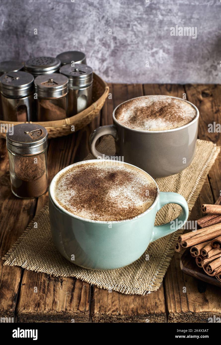 Caffe Latte topped with cinnamon powder served in a cozy coffee shop. Stock Photo