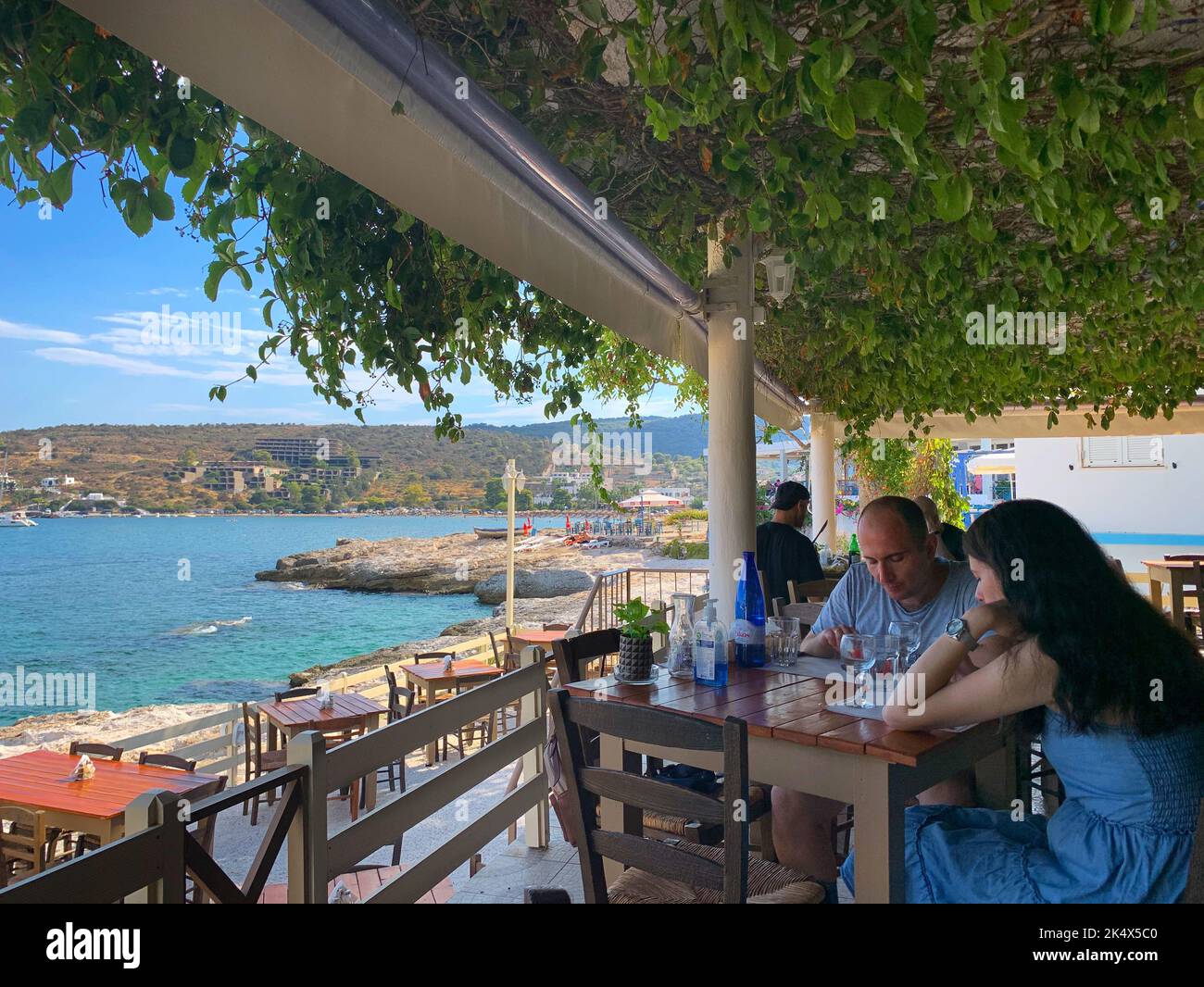 Couple in a traditional Greek taverna, Agia Marina, Aegina, Saronic Islands, Greece Stock Photo