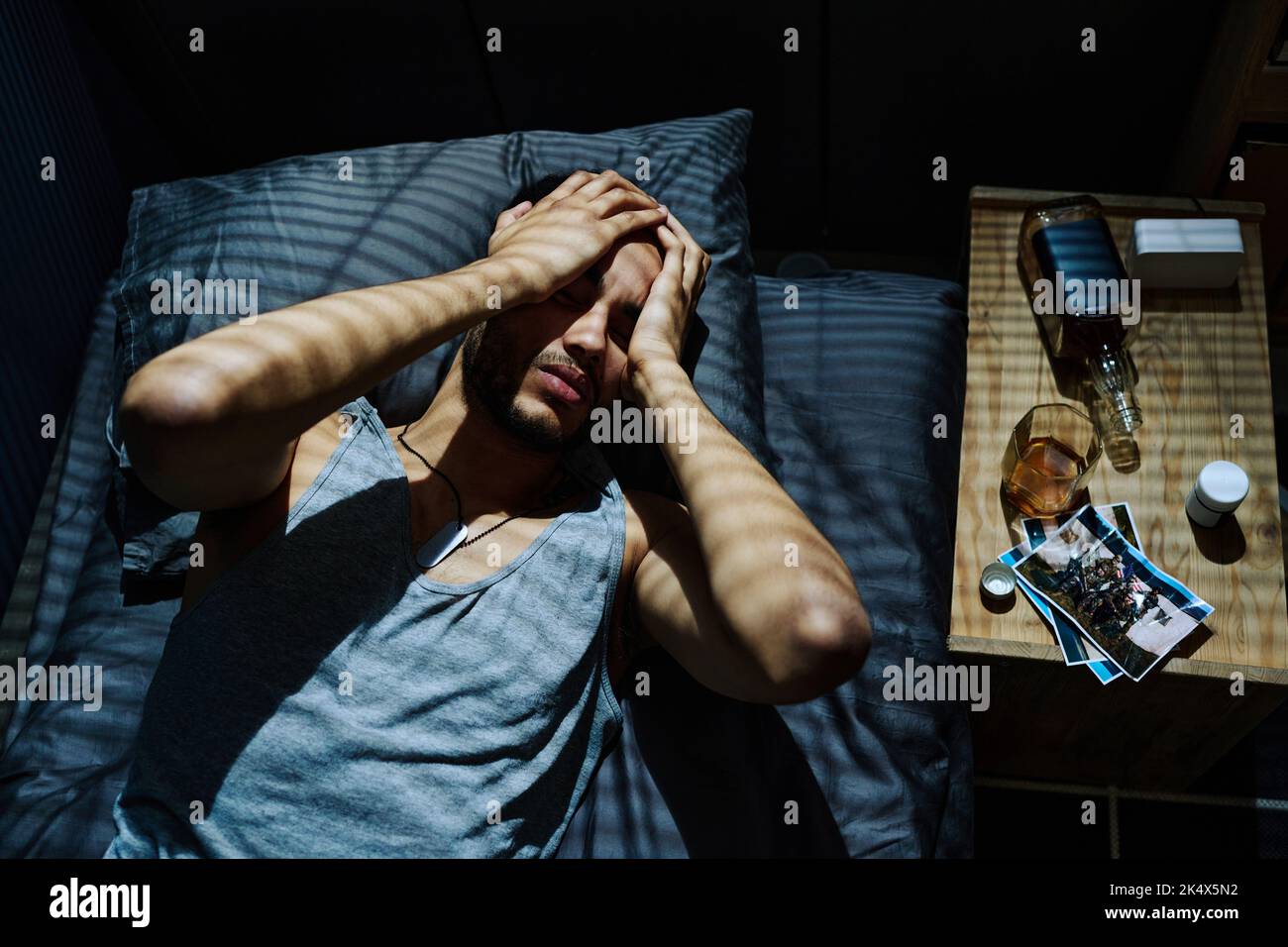 Young man suffering from headache caused by post traumatic syndrome or