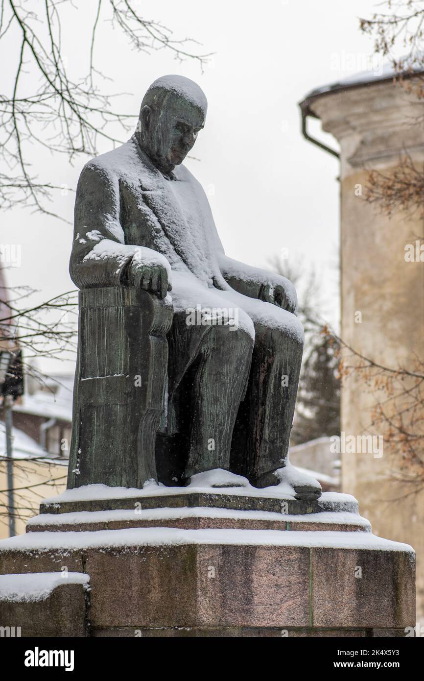 Jozef Montwill bronze statue covered by the snow in Vilnius old town, Polish-Lithuanian social worker, bank owner and philanthropist, vertical Stock Photo