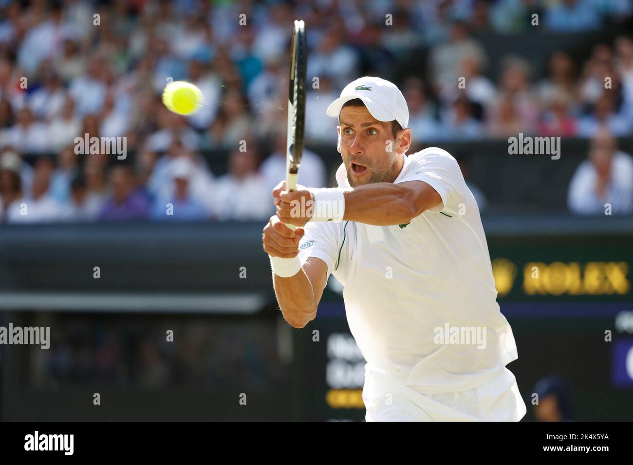 Serbian tennis player Novak Djokovic playing backhand shot during 202 Wimbledon Championships, London, England, United Kingdom Stock Photo