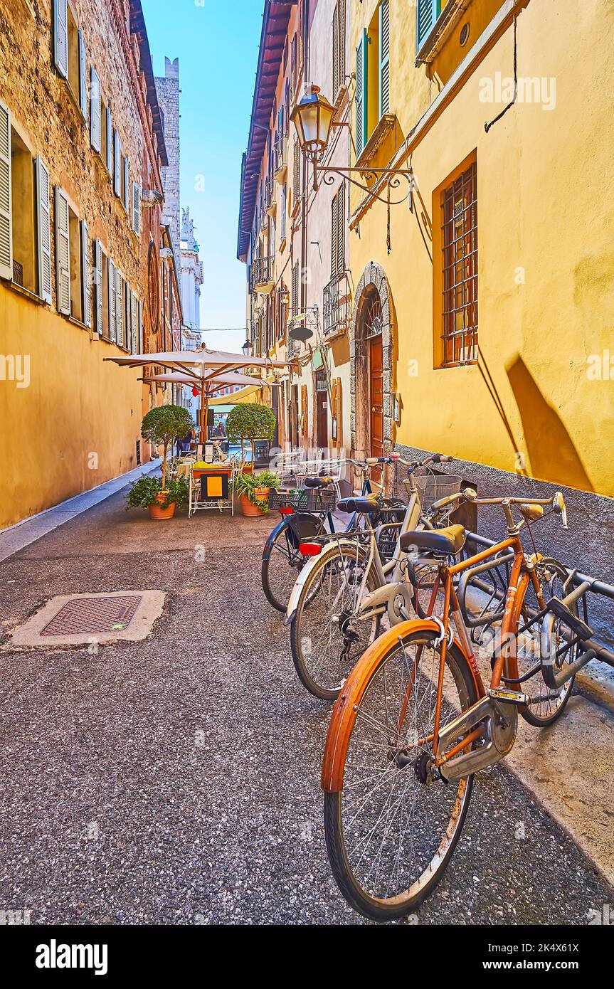 The bike parking along the house wall on Vicolo Sant'Agostino, Brescia, Italy Stock Photo