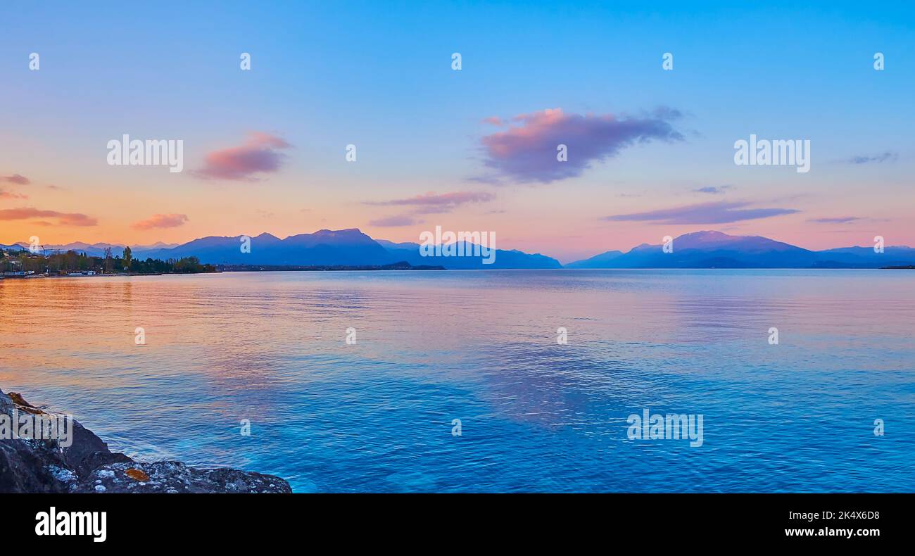 Reflection of dusk sky on rippled surface of Lake Garda, Desenzano del Garda, Italy Stock Photo