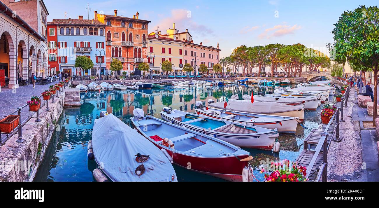 Panoramic view of historic Porto Vecchio (Old Port), lined with medieval houses, cafes and restaurants with a view on the spread pines and sunset sky, Stock Photo