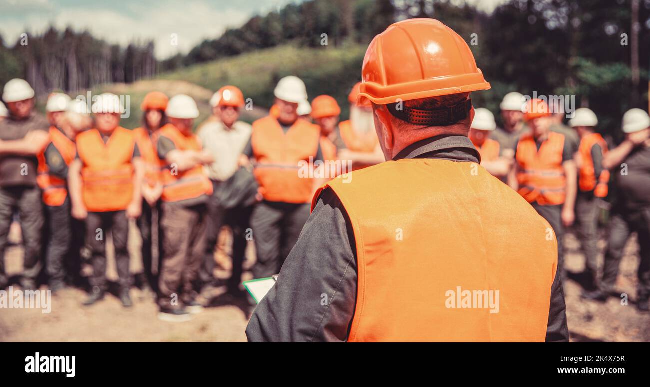 Worker group wearing vest, safety. Building concept. Architector, engineers on constructing site. Builder man Stock Photo