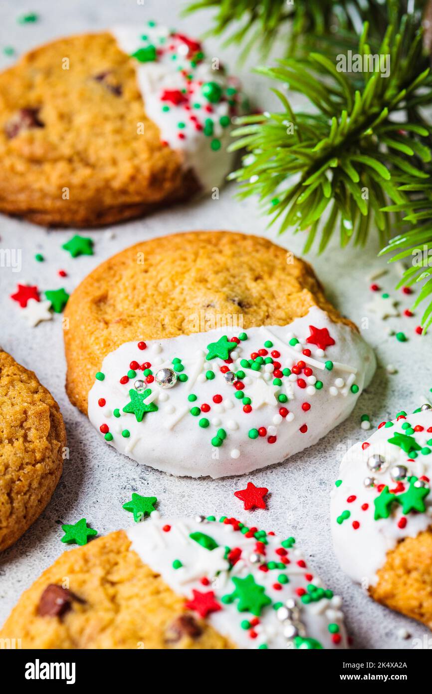 Christmas glazed cookies with festive sprinkles. Holiday dessert concept. Stock Photo