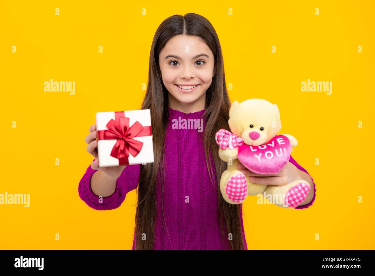 Portrait of a teenager child girl holding present box isolated over ...