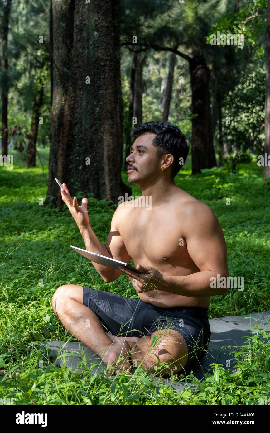 hispanic latino man giving class, while being recorded by a camera, holding tablet in his hand, mexico Stock Photo