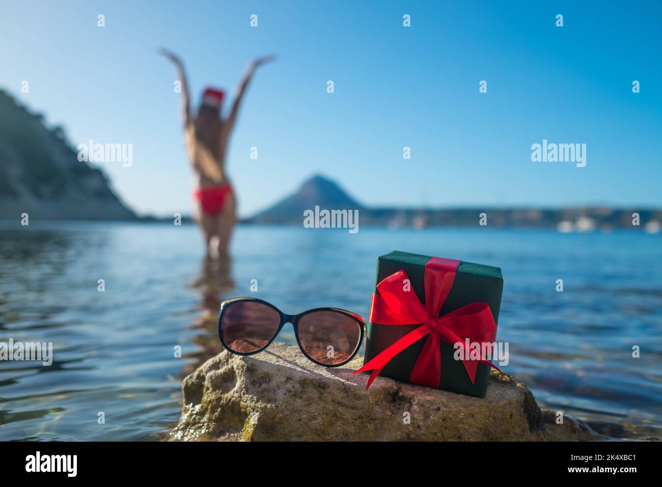 Woman from a back with a long hair, red bikini and in a Santa hat Stock ...