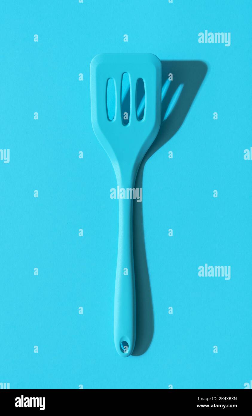 https://c8.alamy.com/comp/2K4XBXN/above-view-with-a-blue-silicone-spatula-in-bright-light-on-a-blue-colored-table-kitchen-utensil-a-silicone-spatula-in-blue-monochrome-settings-2K4XBXN.jpg
