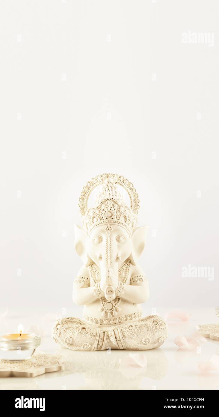 Holiday of Ganesh Chaturthi. Sculpture of ganesha with rose petals and