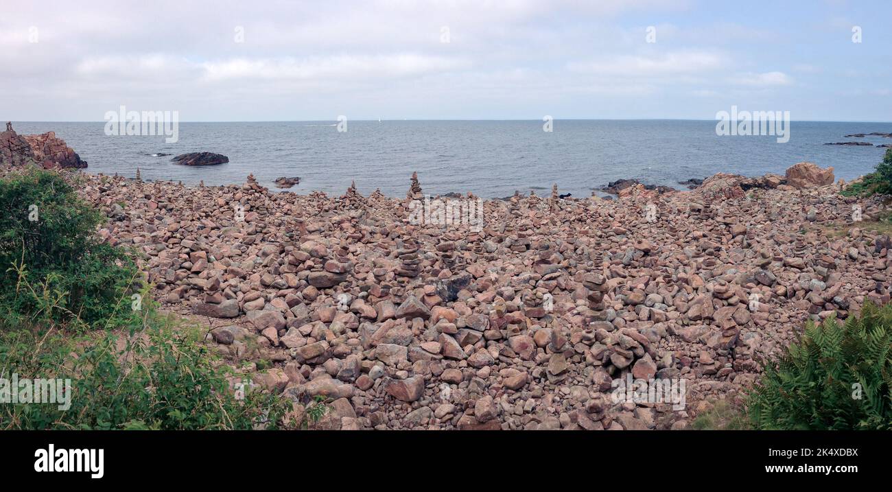 Rocky stone beach at Hovs hallar in Skåne Sweden with lots of stacked stones Stock Photo