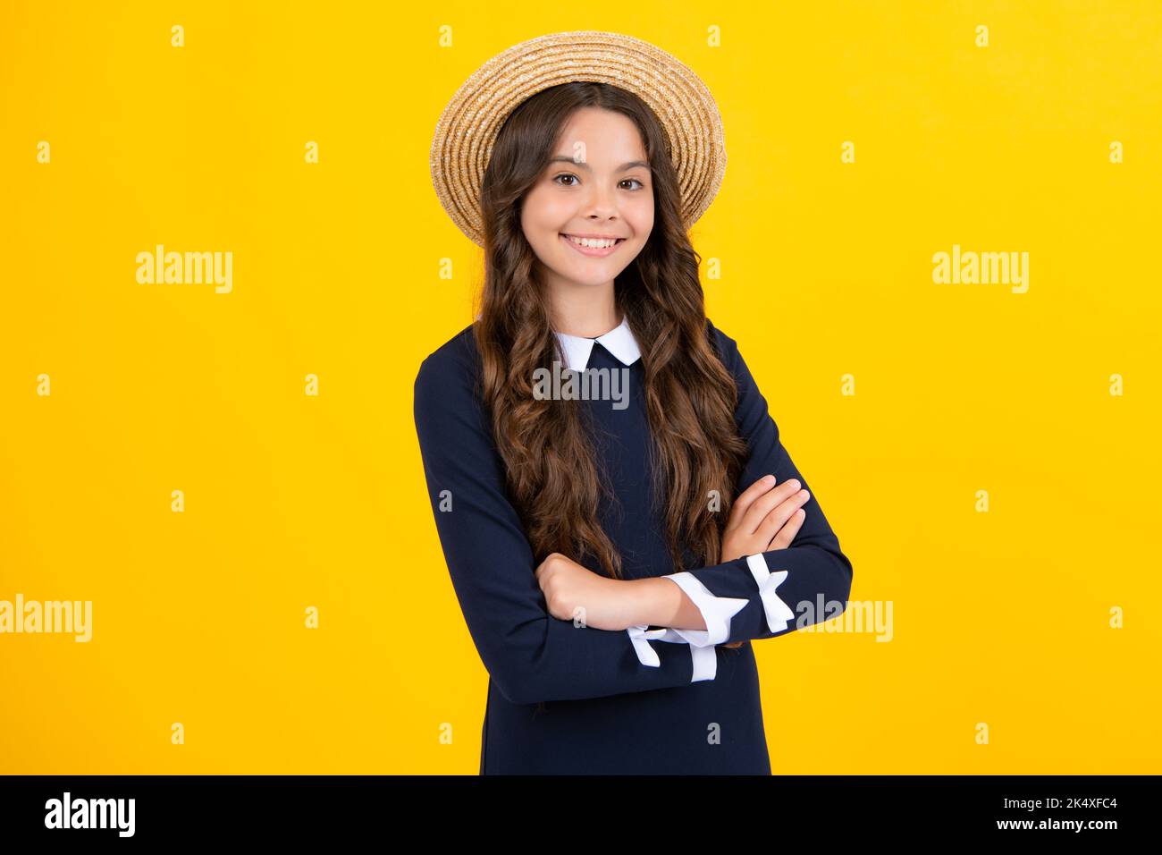 Teenager kid crossed arms with confidence isolated on yellow. Confident teen child girl crossed hands. Stock Photo